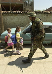 Kosovo trip
Members of the 40th engineers stationed at Camp Monteith, walk a foot patrol through the town of Gjilan.
Sgt. Antonio Tyson pass children on the street.