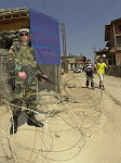 Kosovo trip
Specialist Mike Milan of Beverly, a member of the 40th Combat Engineers stationed at Camp Monteith, guards a checkpoint near a Serb area in the town of Gjilan.